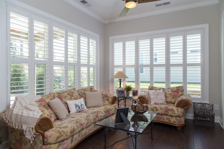 Airy sunroom with plantation shutters in Denver.